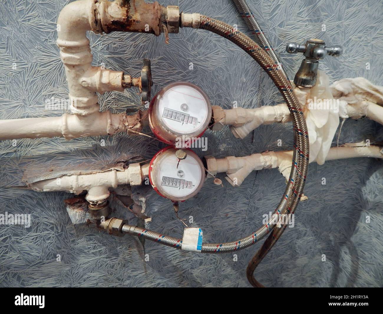 Old water pipes and water meters. Plumbing in the apartment Stock Photo
