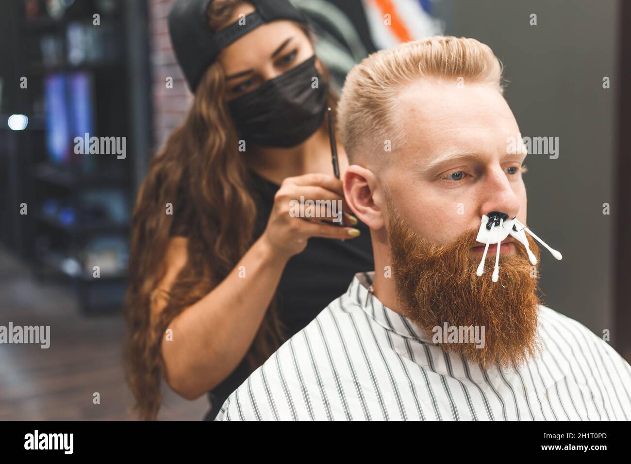 beard modeling in Barber shop, removing hair from the nose and ears with wax, male beauty and