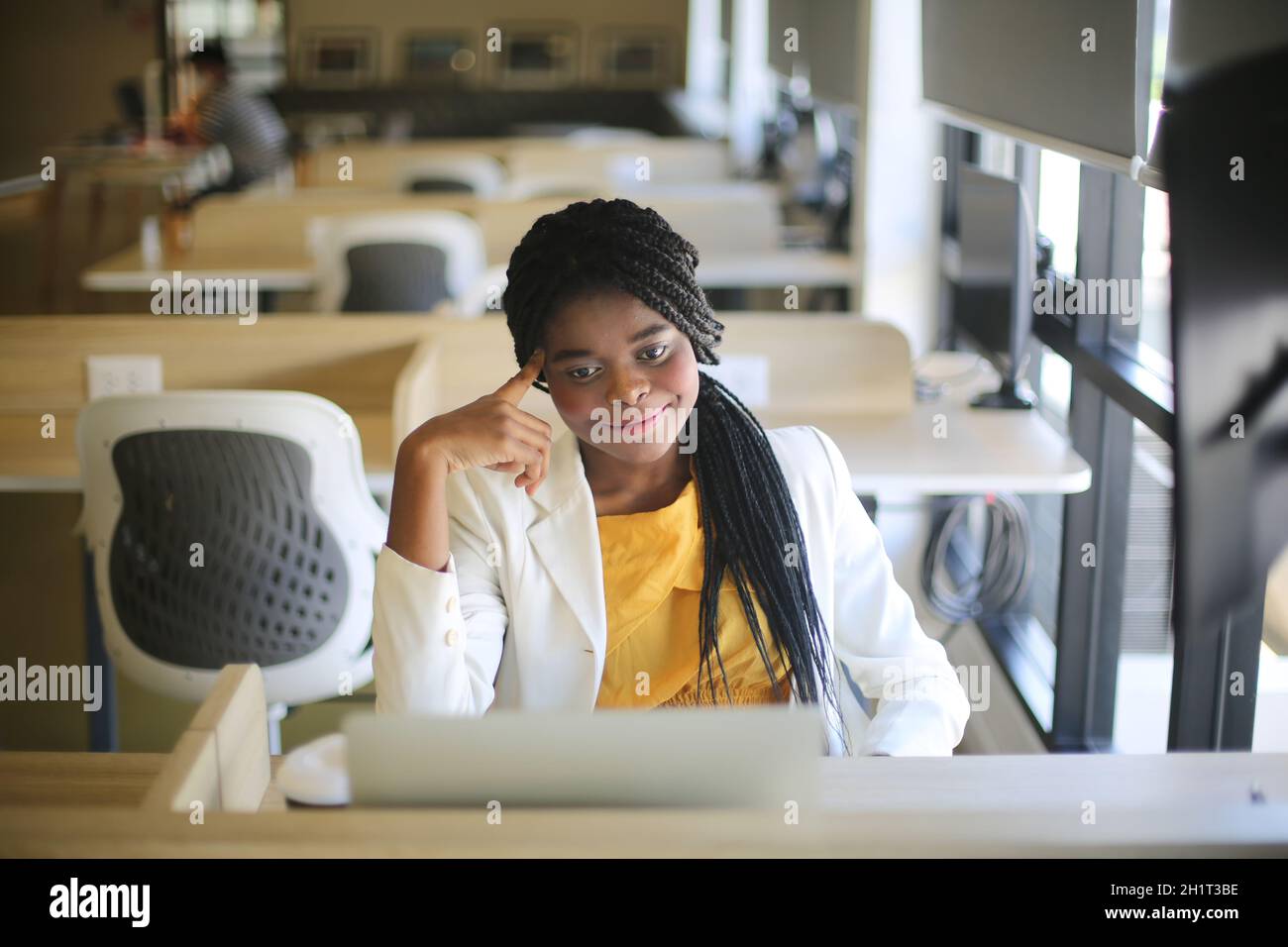 Young African American woman working using computer laptop concentrated ...
