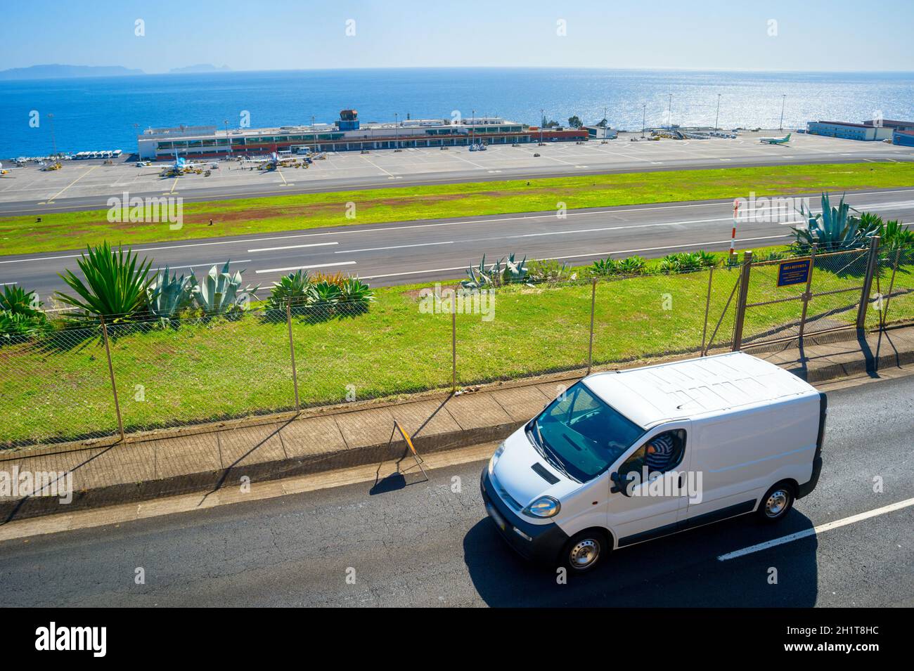 Car on a road in front of Madeira international airport. Funchal, Madeira, Portugal Stock Photo