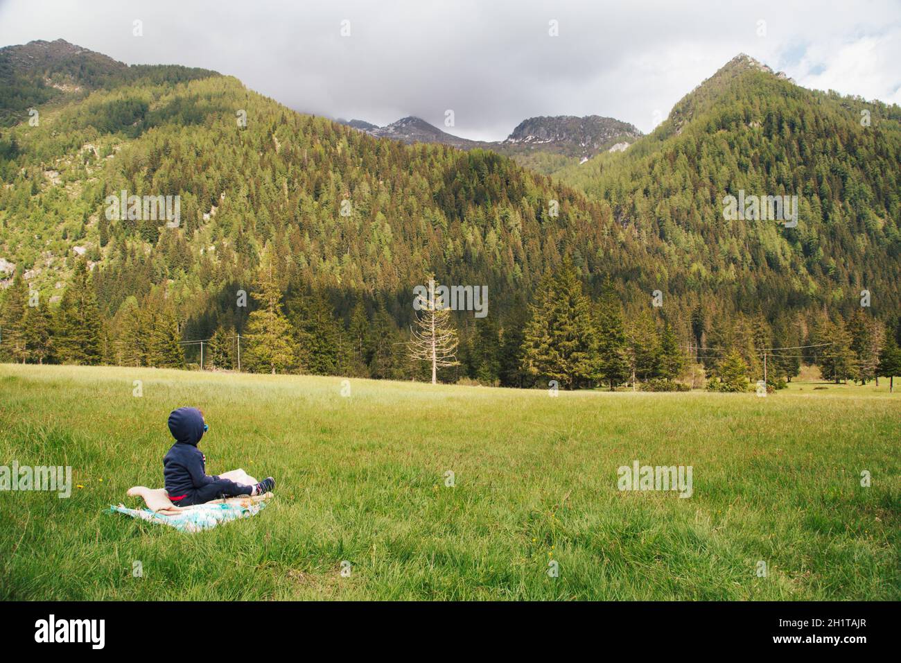 Family picnic in middle of nature. Wide-open spaces. Gaver locality, Valle Sabbia, Lombardy region in Italy. Concept of vacation in high mountains. Se Stock Photo