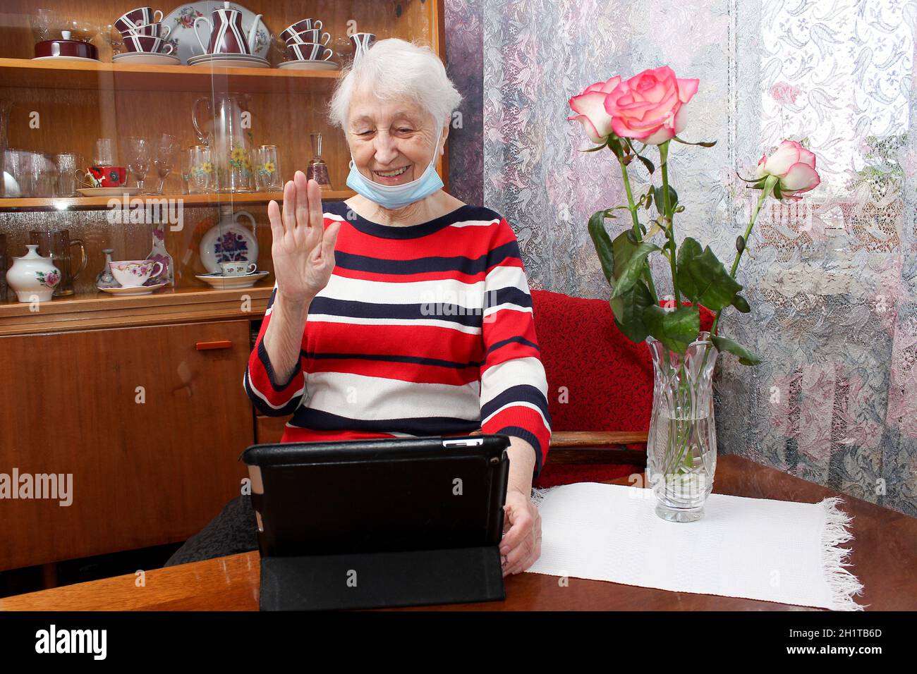 COVID-19 Stay connected. Happy senior woman at home video calling family on laptop or online chatting with long distance friends. Coronavirus lockdown Stock Photo