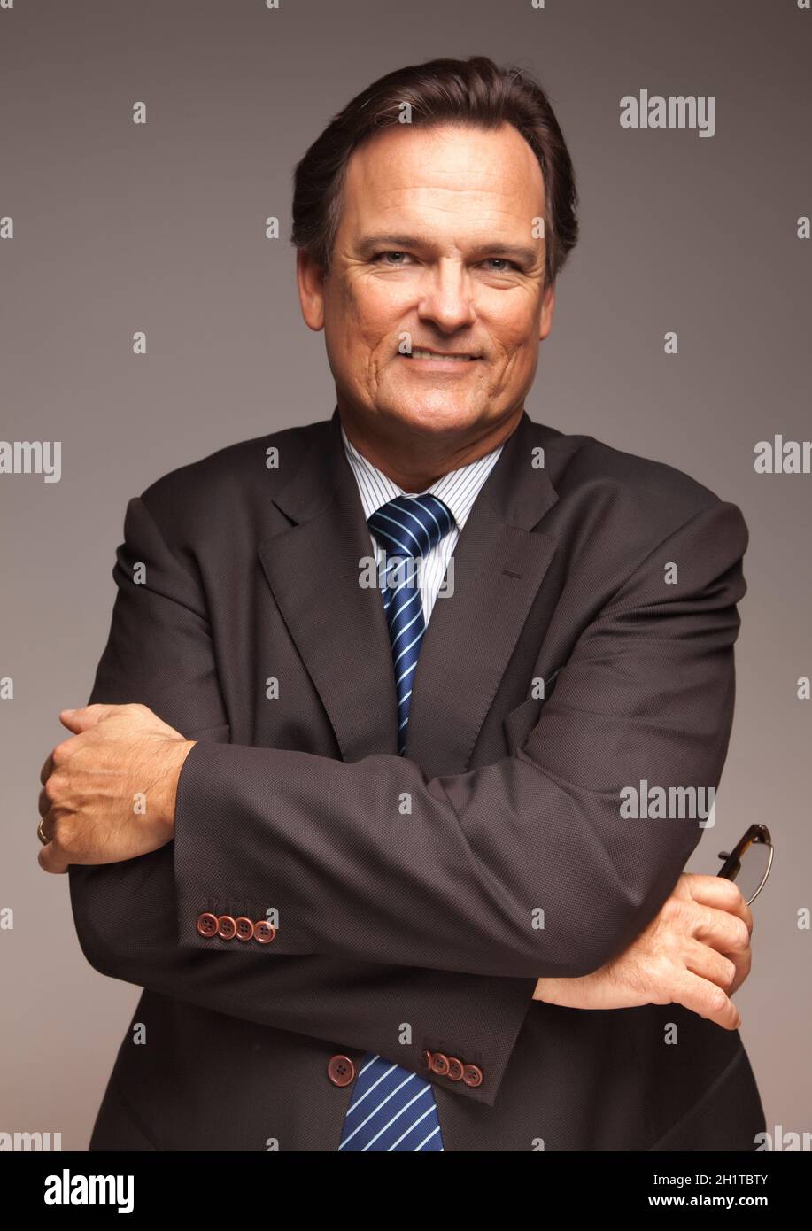 Handsome Businessman Smiling in Suit and Tie Isolated on a Grey ...