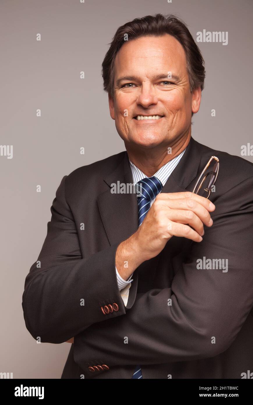 Handsome Businessman Smiling in Suit and Tie Isolated on a Grey ...
