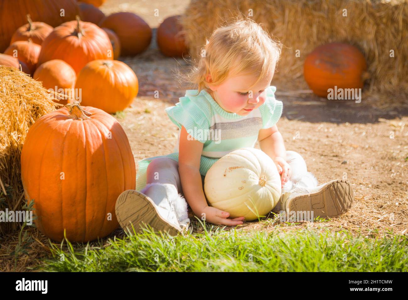 Adorable Baby Girl with Cowboy Hat in a Country Rustic Setting at the  Pumpkin Patch Stock Photo - Alamy