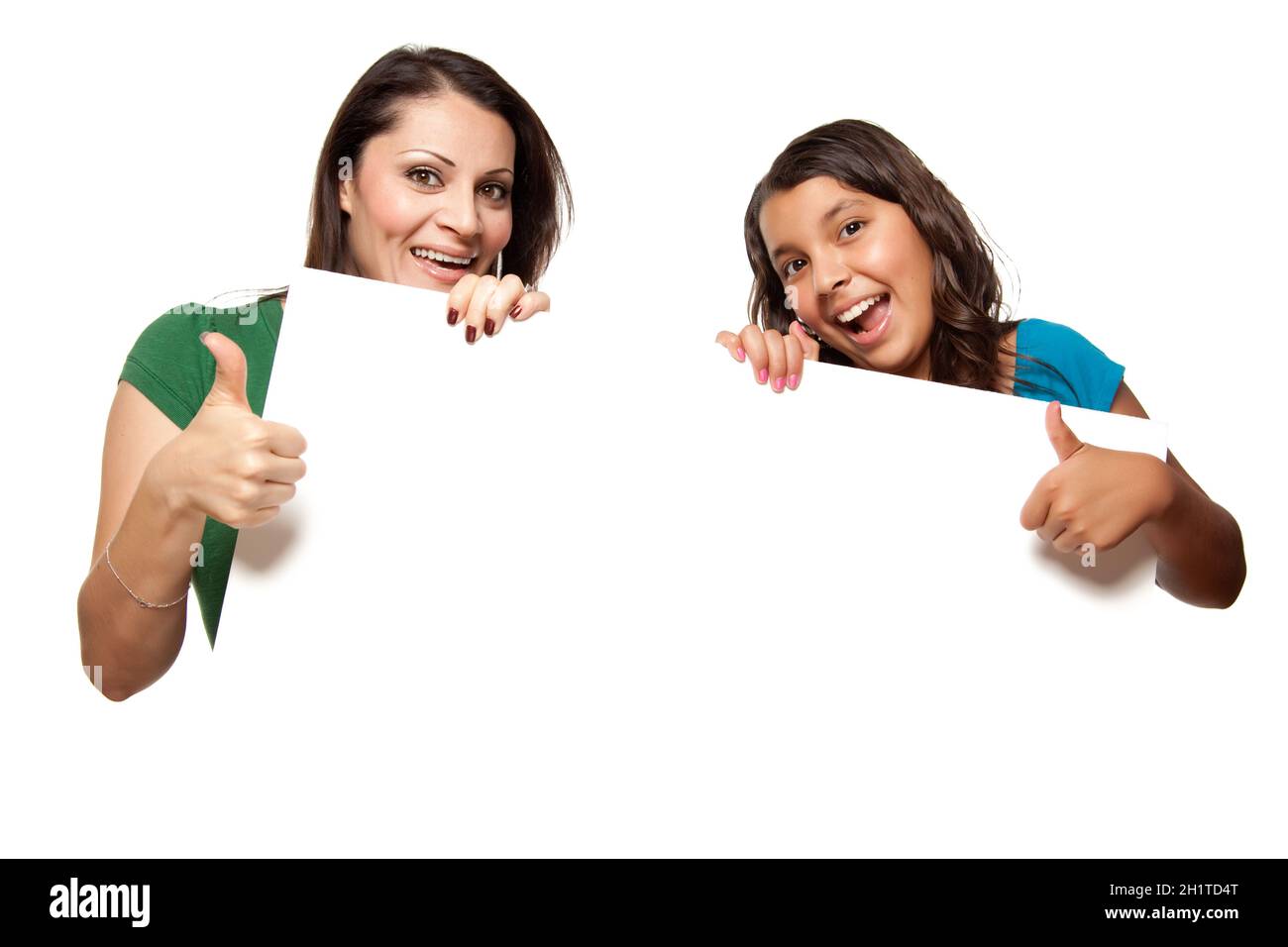 Pretty Hispanic Girl and Mother Holding Blank Board Isolated on a White Background. Stock Photo