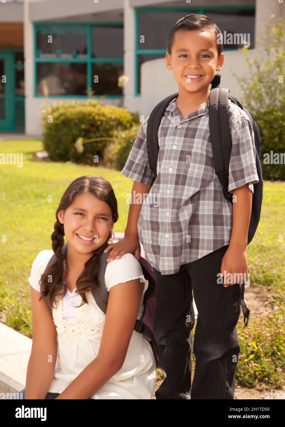 Cute Hispanic Brother and Sister Wearing Backpacks Ready for School. Stock Photo