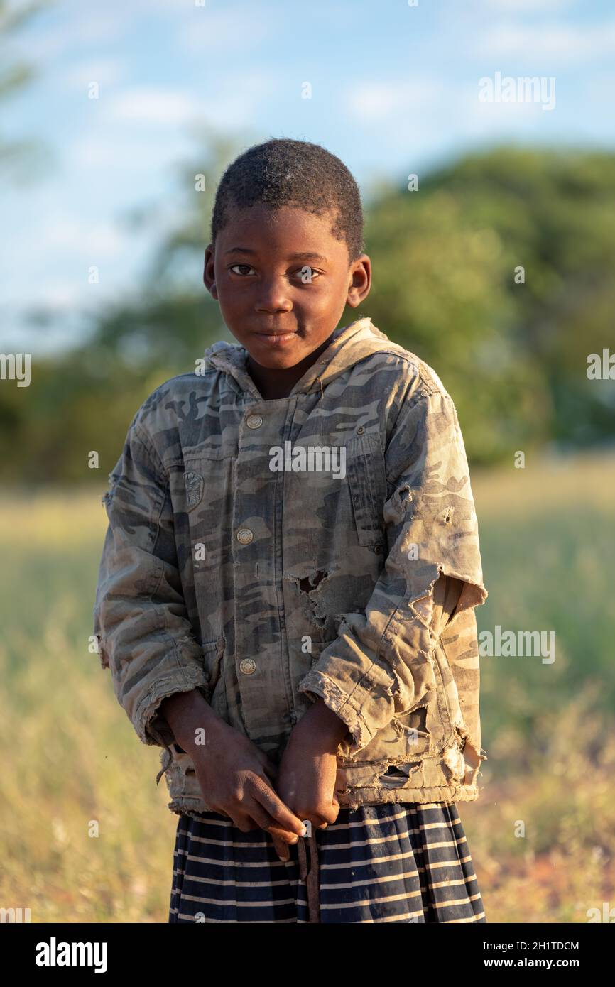 NAMIBIA, OMUSATI REGION, MAY 7: African girl in early cold morning on the road to city Opuwo. Northern Namibia, May 6, 2018, Namibia Africa Stock Photo