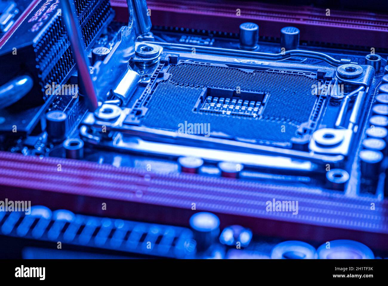 Detail of a Cpu socket in a motherboard of a gaming pc in bluie light ...