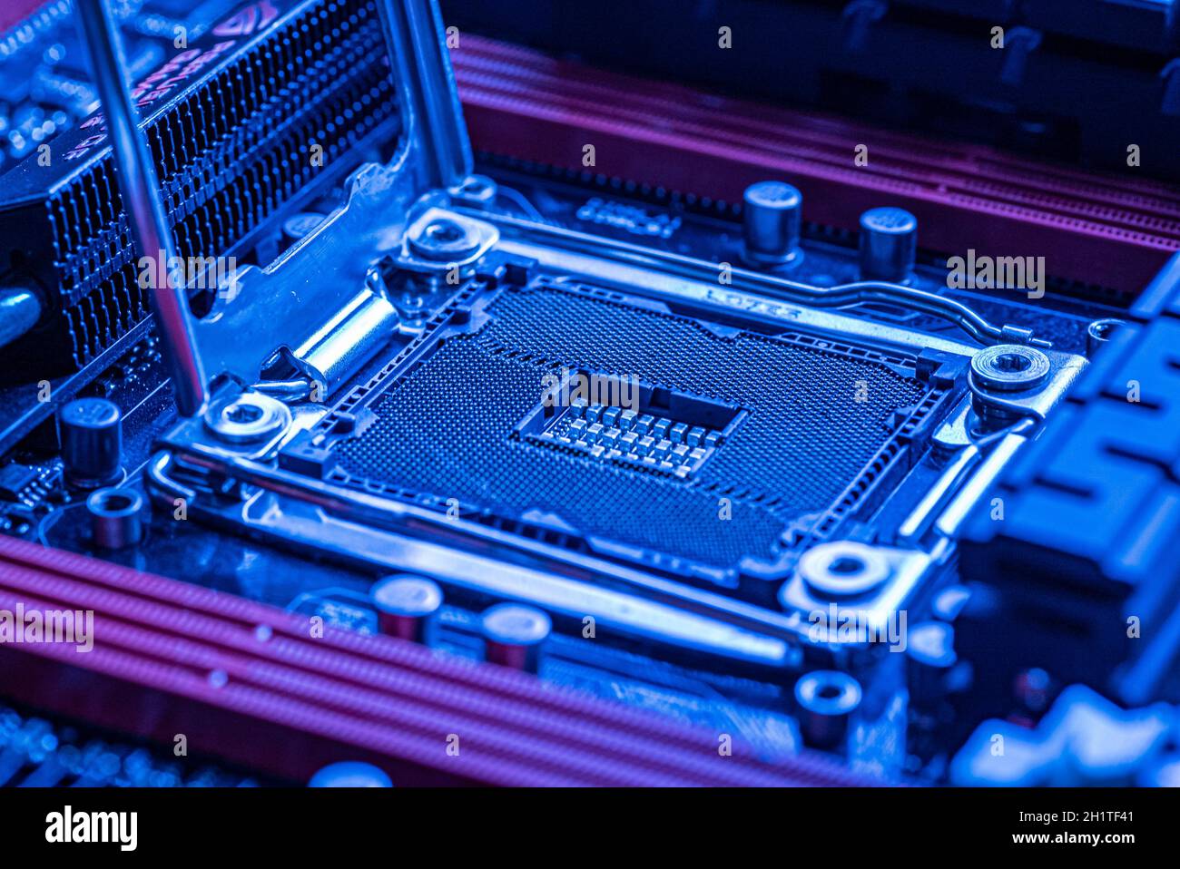 Detail of a Cpu socket in a motherboard of a gaming pc in bluie light Stock Photo