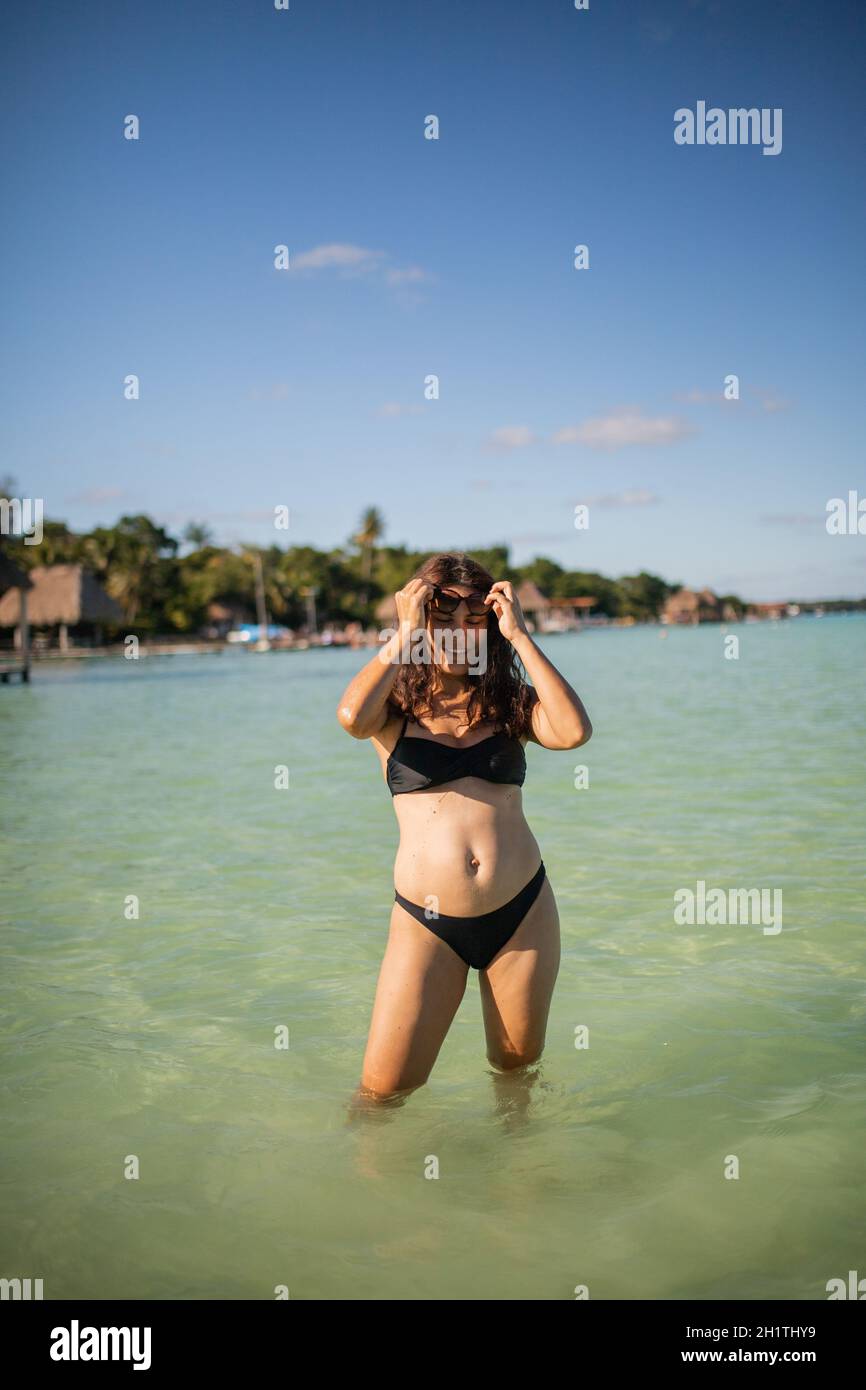Beautiful Young Sexy Woman Standing In Black Bikini Next To