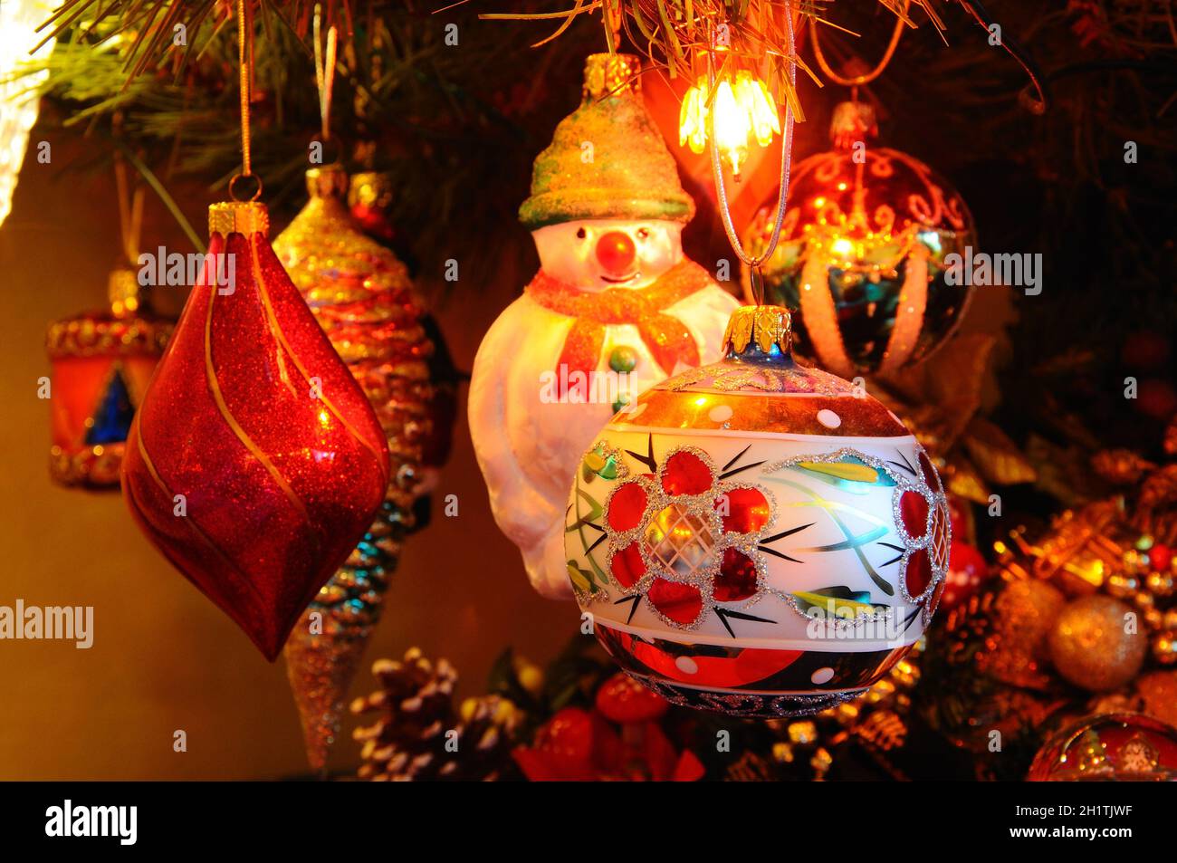 Glass Christmas Tree Decorations hanging in an ornamental tree Stock ...