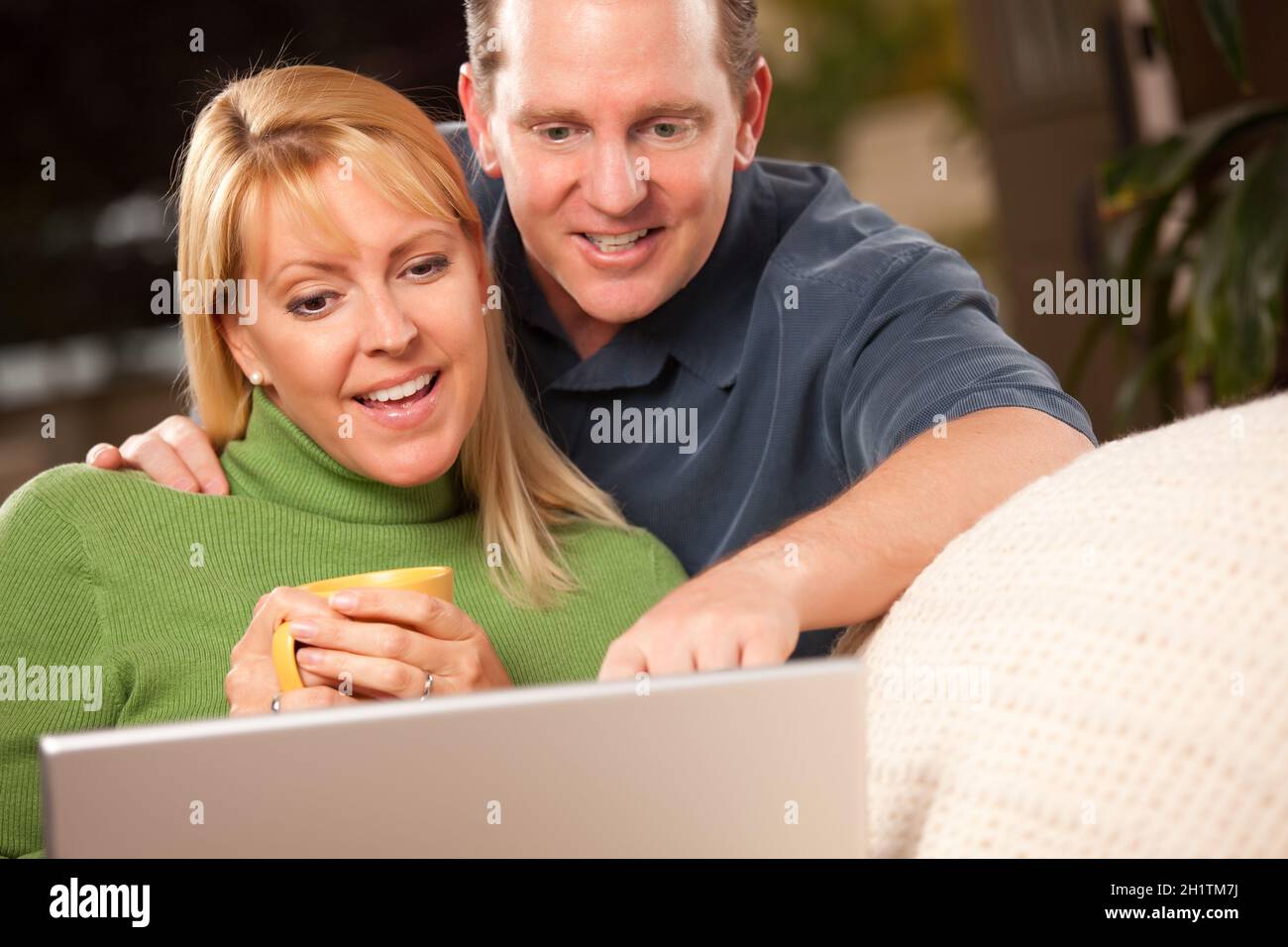 Handsome Happy Couple Using Their Laptop Together Stock Photo - Alamy