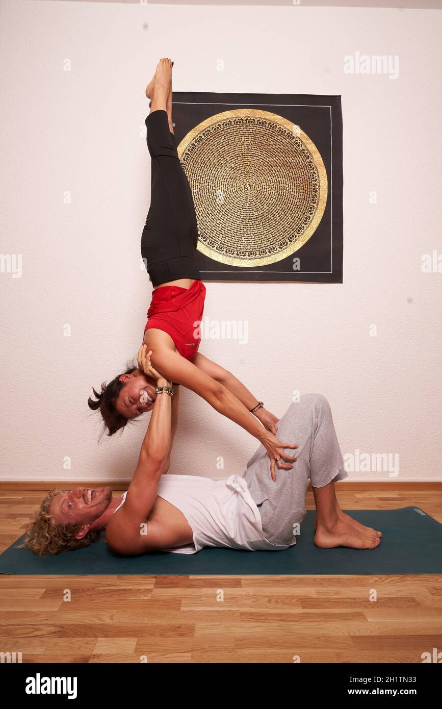 women and men practice acrobatics yoga Stock Photo
