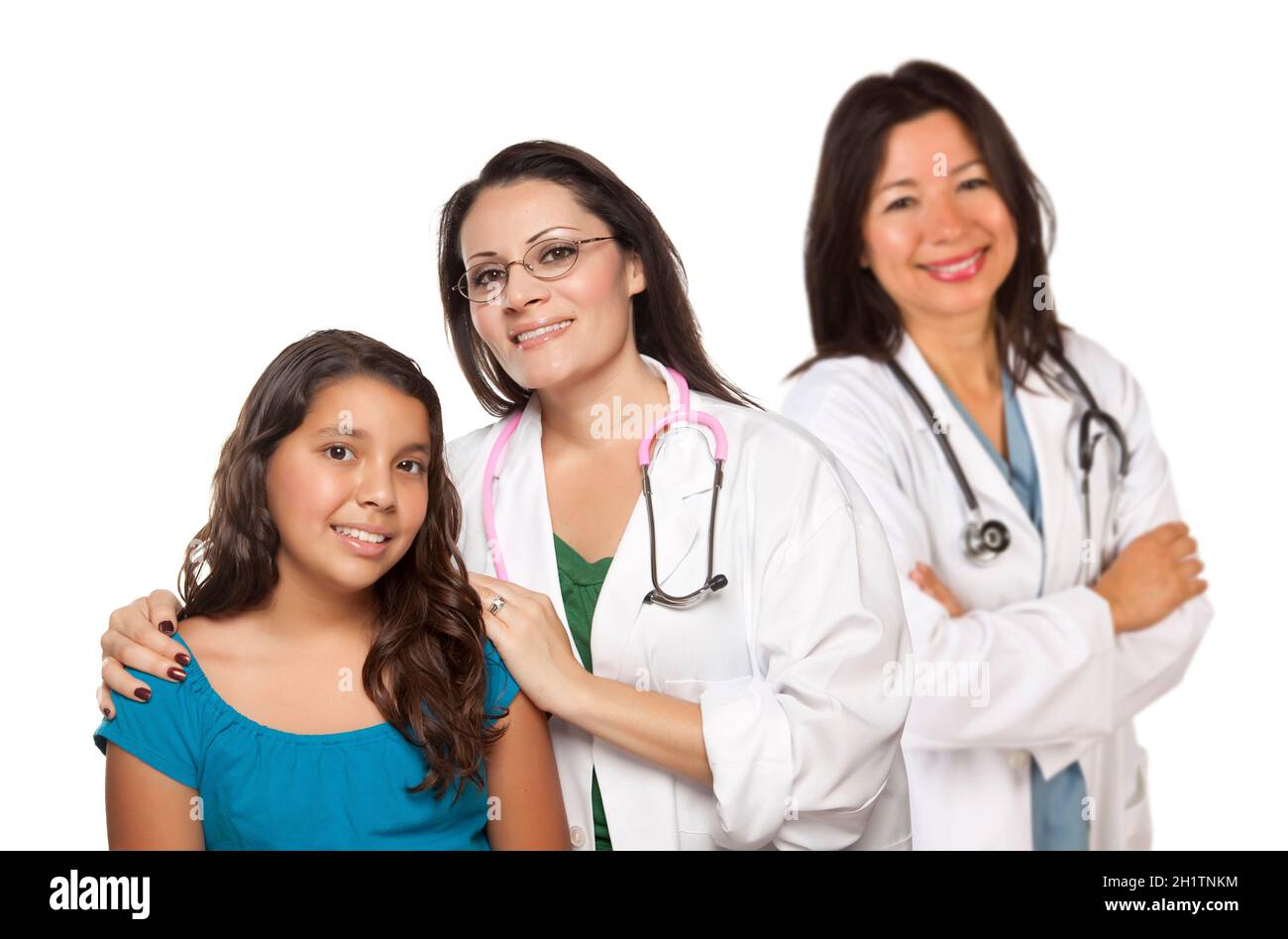 Pretty Hispanic Female Doctor with Child Patient and Colleague Behind