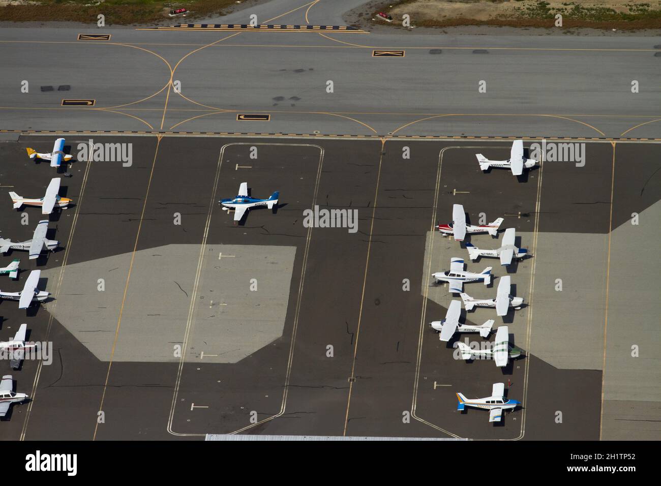 Light planes parked at San Carlos Airport, San Francisco, California, USA - aerial Stock Photo