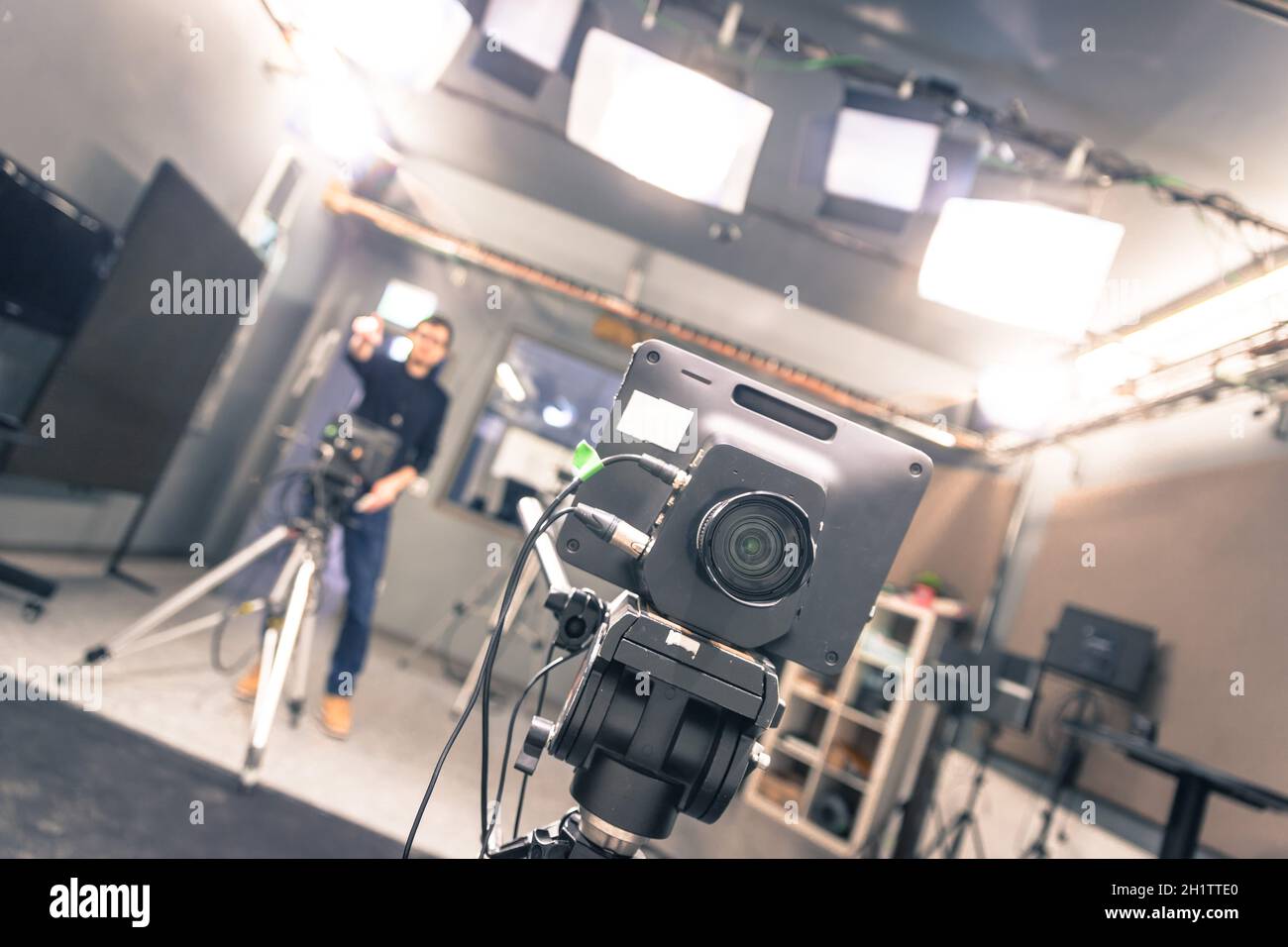 Lens of a film camera in an television broadcasting studio, spotlights