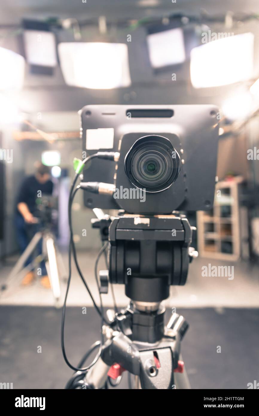 Lens of a film camera in an television broadcasting studio, spotlights