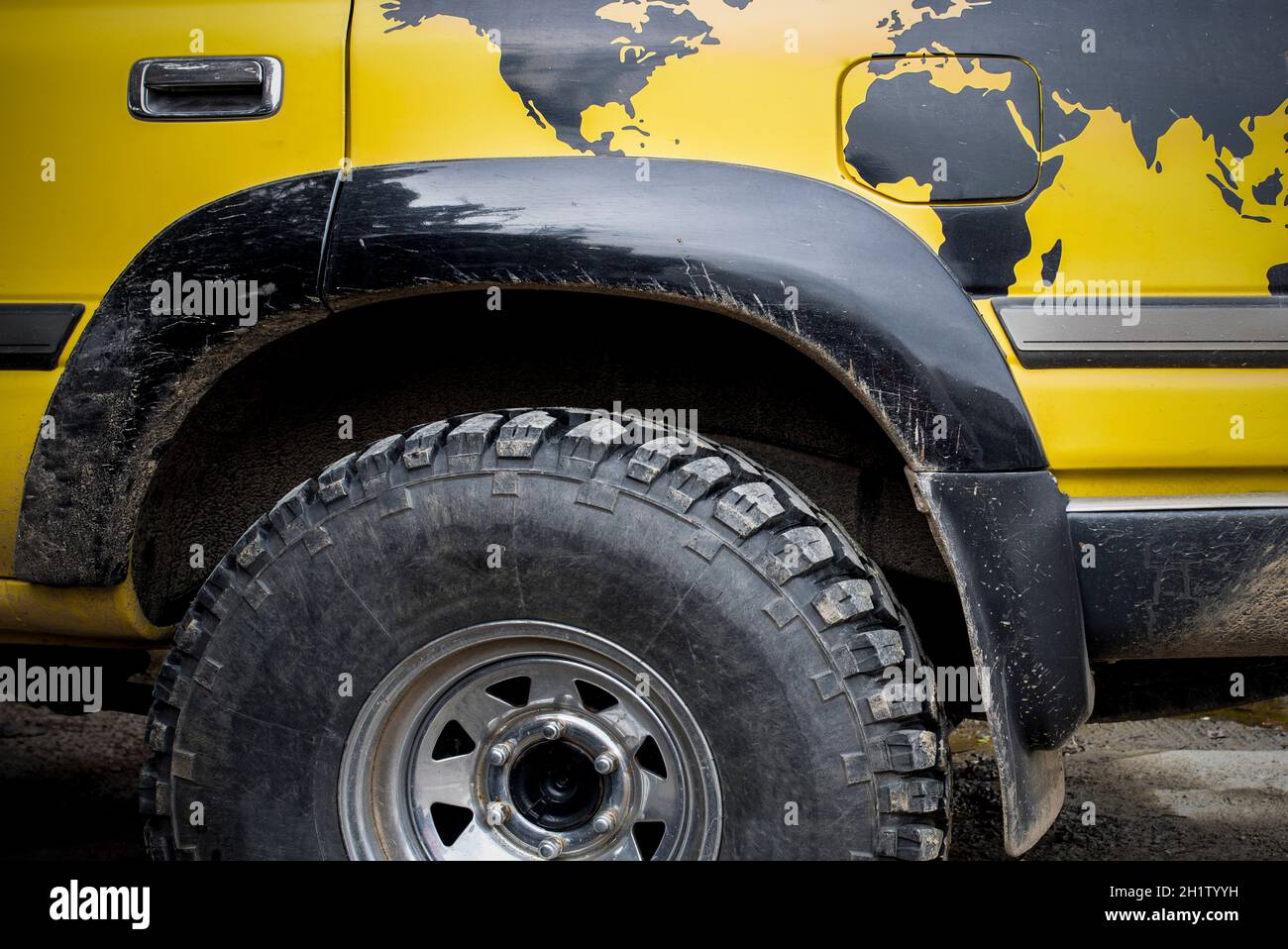 World traveller off road vehicle. A world map is painted over rear wheel Stock Photo