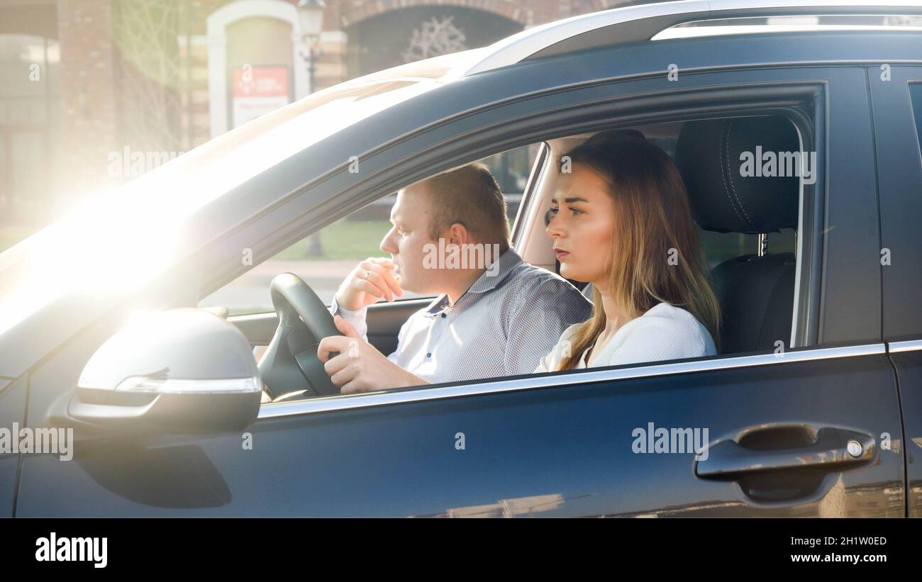 Portrait of family driving a car got lost and looking for the road. Stock Photo