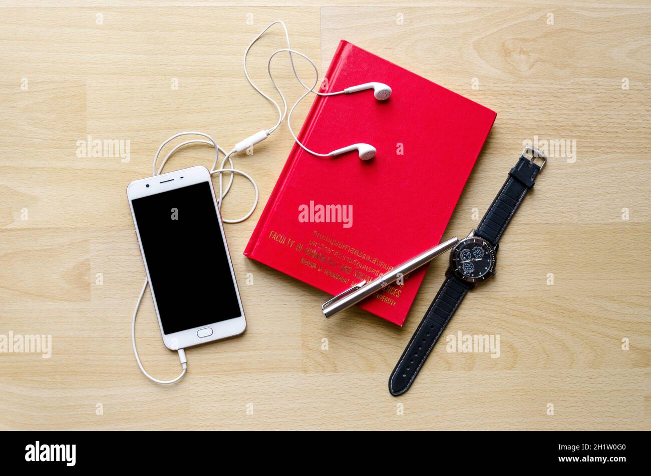 Telephone Notebook Red Red Book Cover blank notebook with pen on wood table And a wrist watch ...