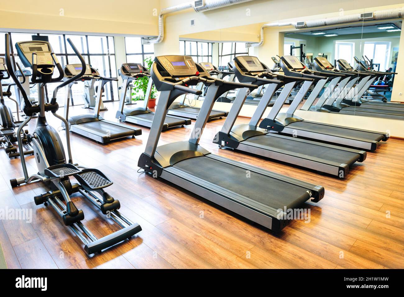 Set of treadmills staying in line in the gym Stock Photo - Alamy