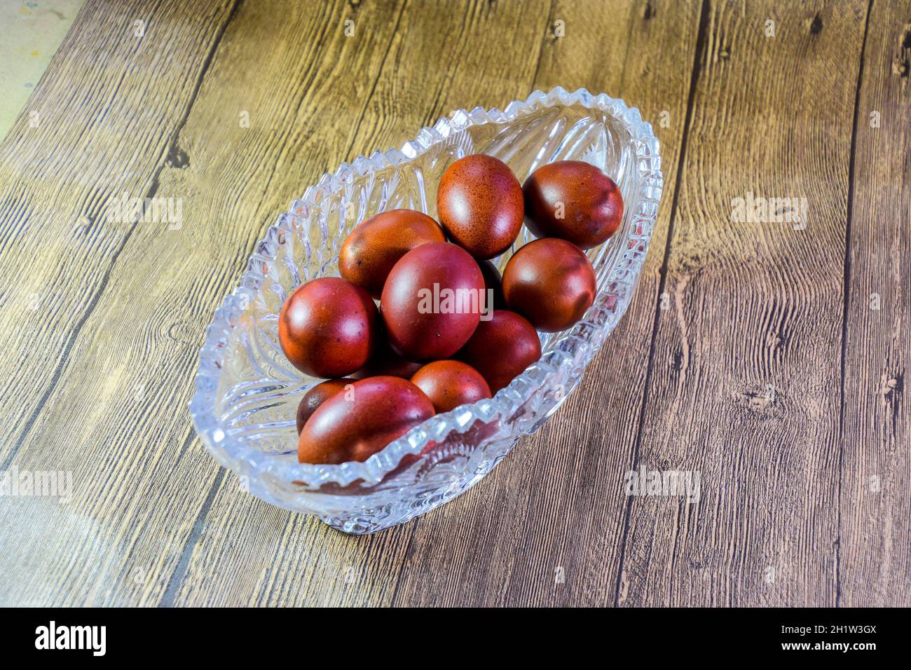 Painted Easter eggs in a crystal vase. Red painted chicken eggs for easter. Stock Photo