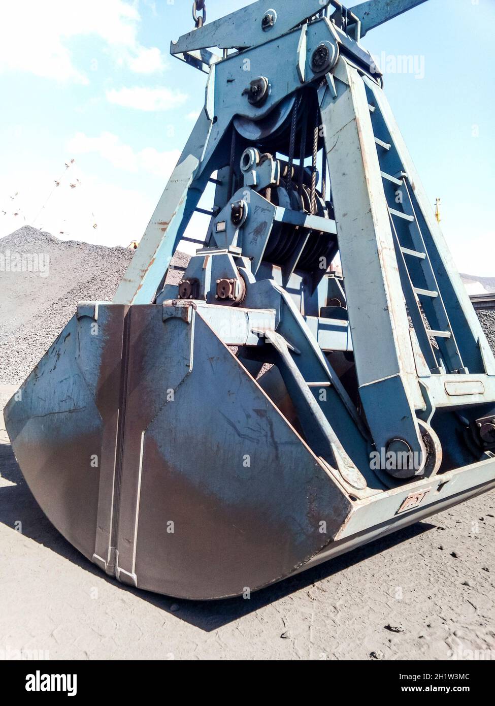 Clamshell bucket in the cargo port. Bucket for loading coal. Stock Photo