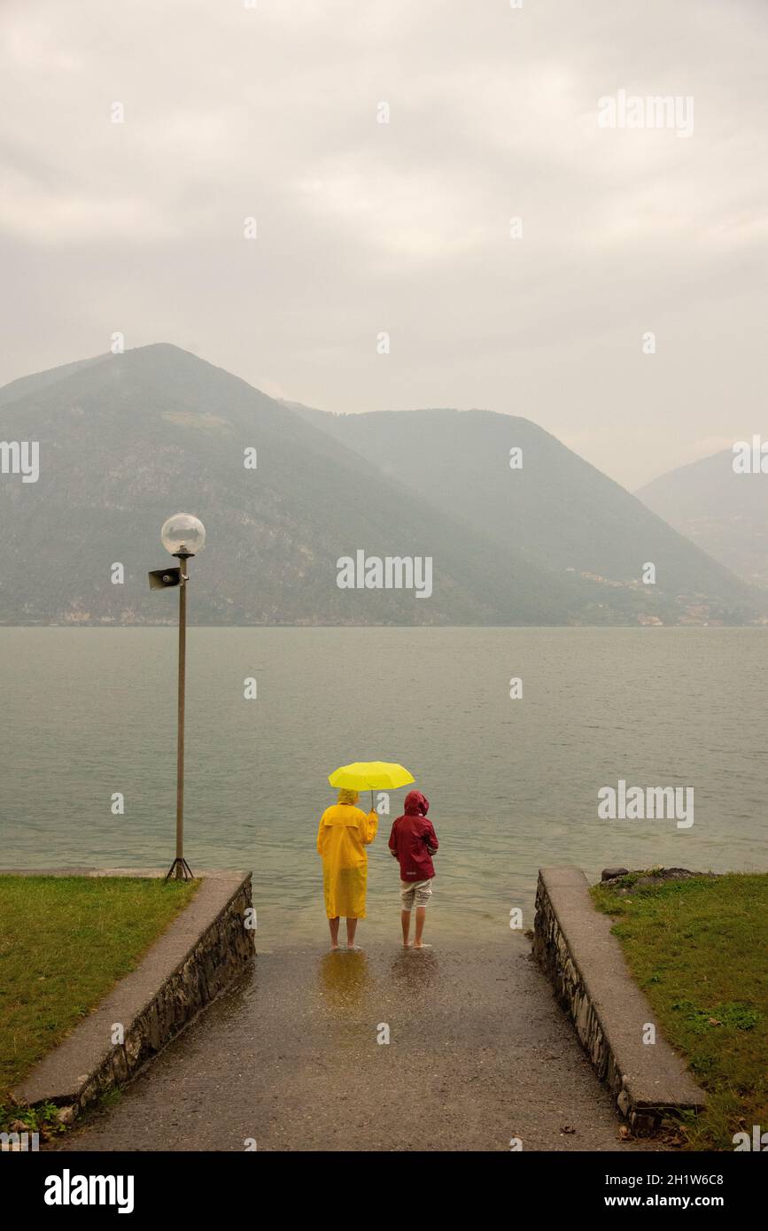 couple at Lake Iseo at a rainy day, Italy Stock Photo