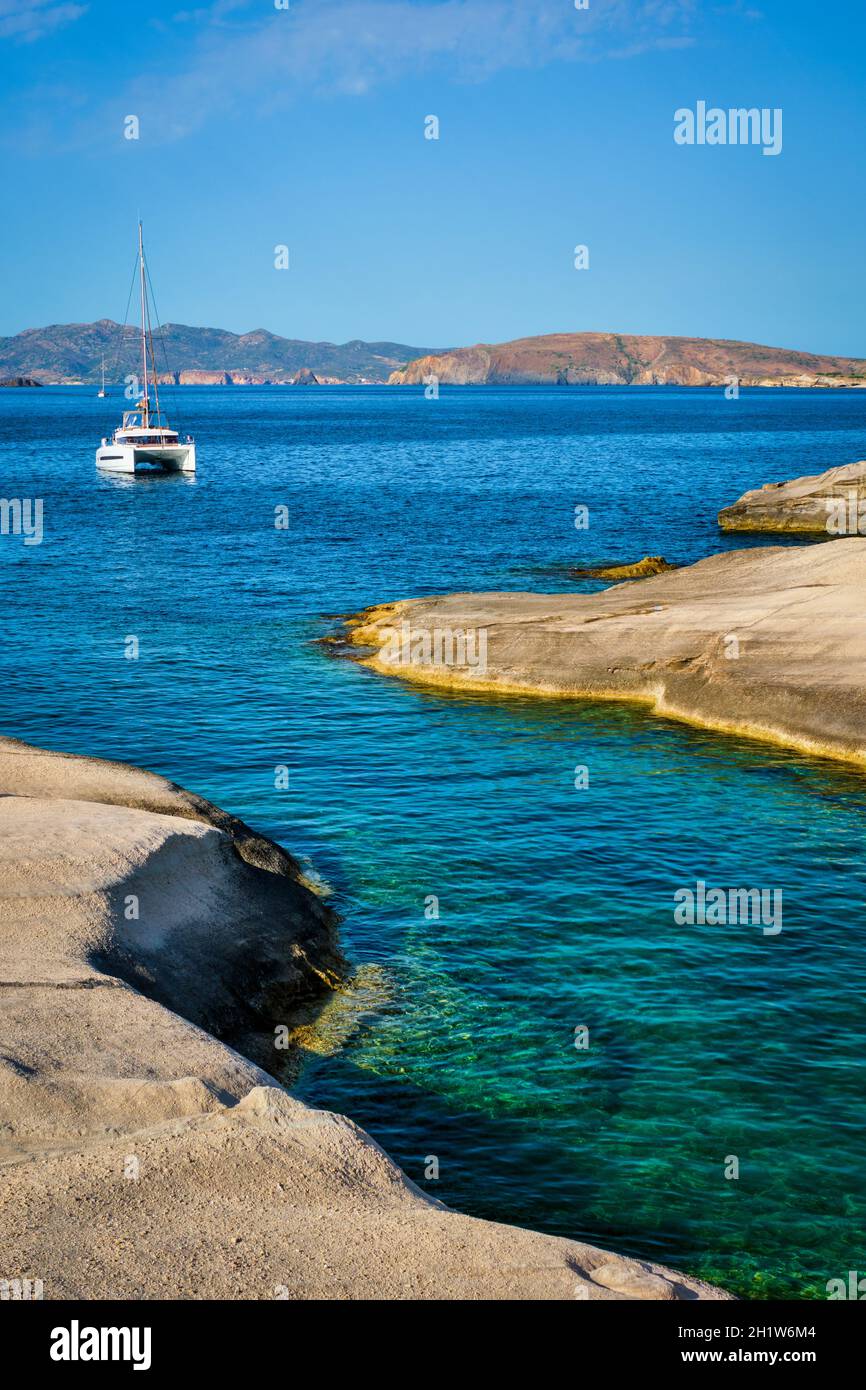 Yacht boat in Aegean sea at white rocks of Sarakiniko Beach Milos