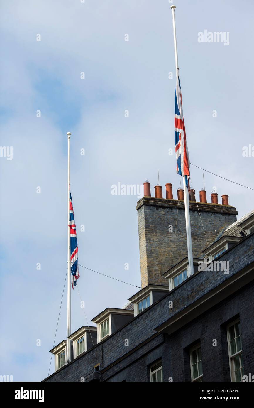 Union Flags fly at halfmast on the top of the building that houses 10
