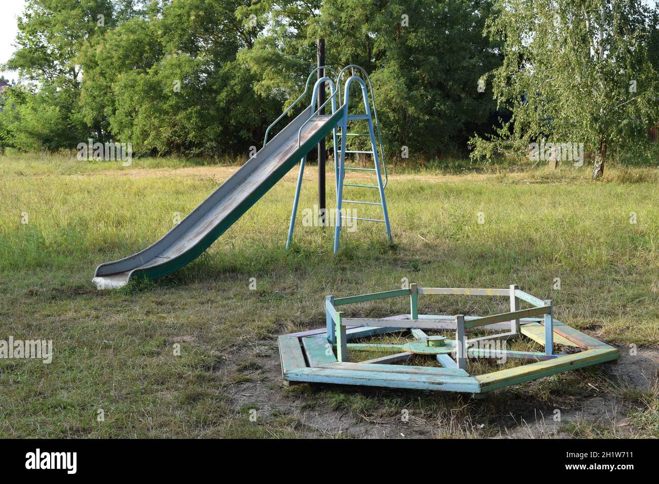 Children playground. Swings and a slide to slide. Stock Photo