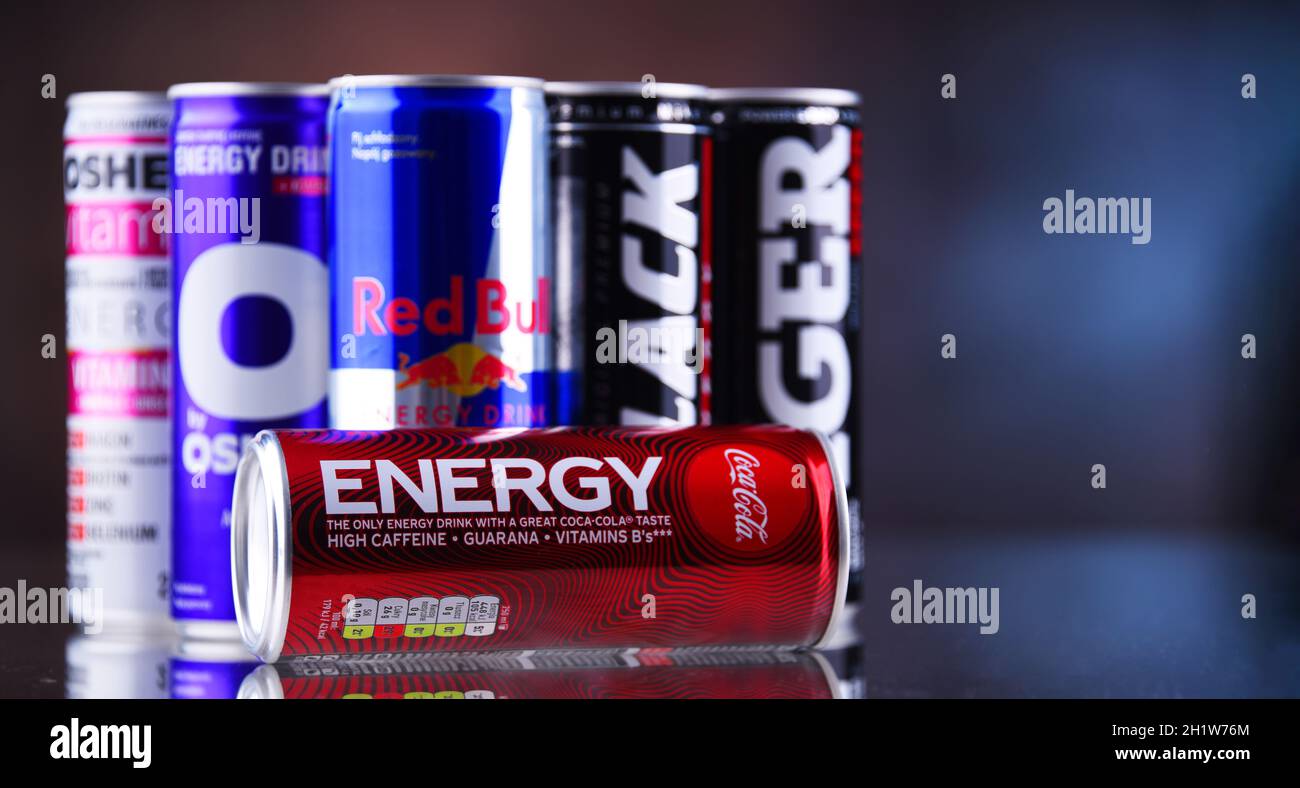 POZNAN, POLAND - MAY 13, 2021: Cans of popular global energy drinks, beverages containing stimulant drugs and marketed as providing mental and physica Stock Photo