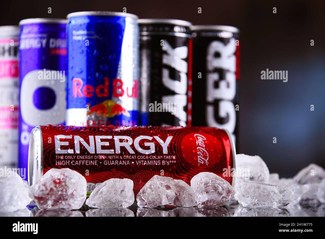 POZNAN, POLAND - MAY 13, 2021: Cans of popular global energy drinks, beverages containing stimulant drugs and marketed as providing mental and physica Stock Photo