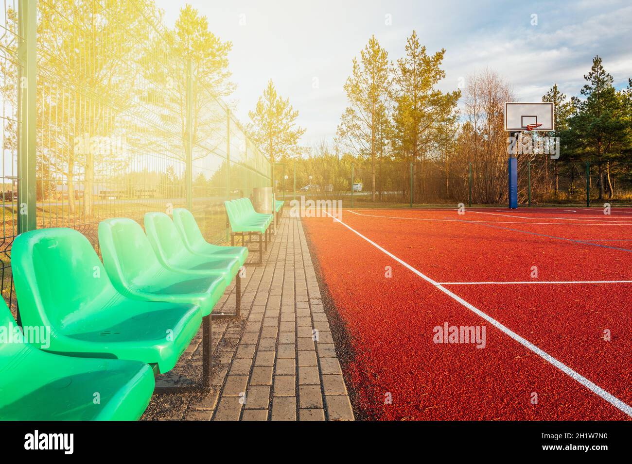 Outdoor basketball court with empty chairs during lockdown Stock Photo