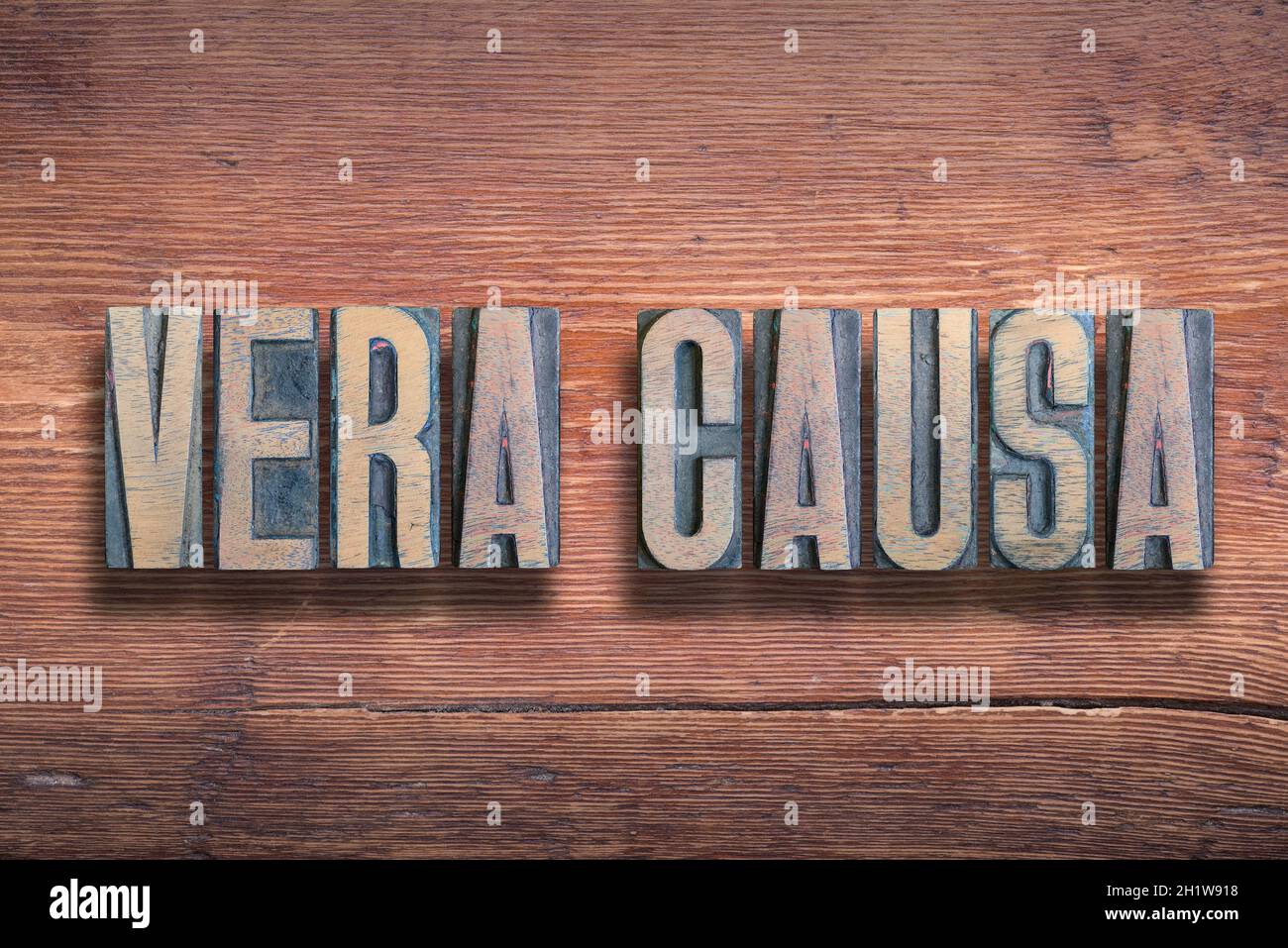 vera causa ancient Latin saying meaning - true case, combined on vintage varnished wooden surface Stock Photo
