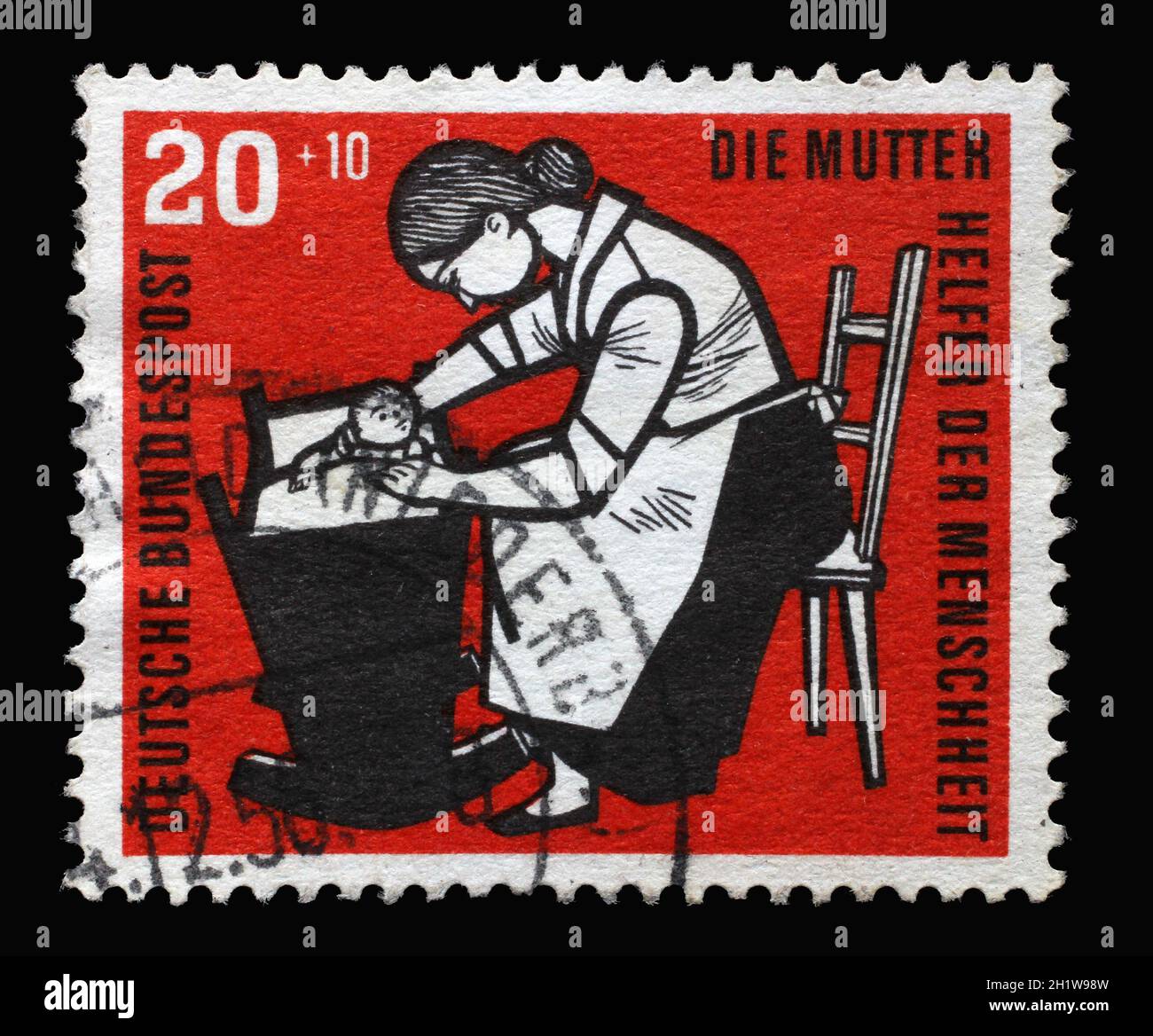 Stamp printed in Germany, shows Mother with baby cradle, circa 1956 Stock Photo