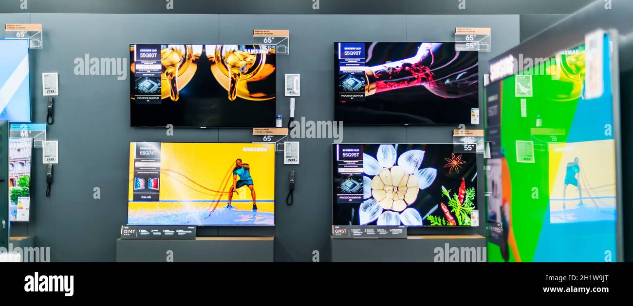 POZNAN, POL - MAY 28, 2021: Modern flat-screen TV sets by Samsung put up for sale in an electronics store Stock Photo