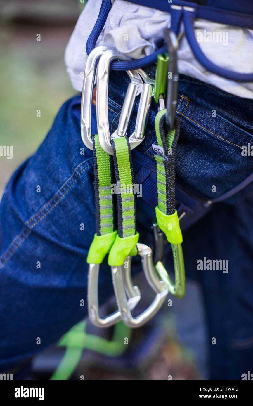 Various rock climbing gear attached to harness Stock Photo Alamy