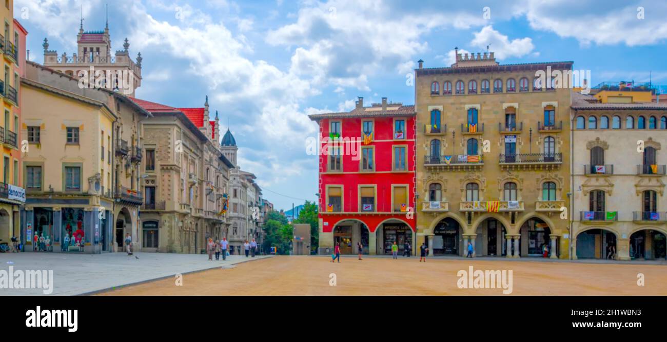 The blurred Plaza Mayor in Vic on a sunny day filled with tourists, Catalonia, Spain Stock Photo