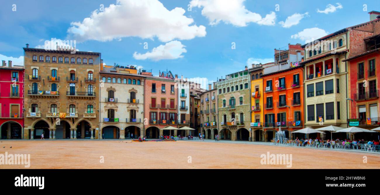 The blurred Plaza Mayor in Vic on a sunny day filled with tourists, Catalonia, Spain Stock Photo