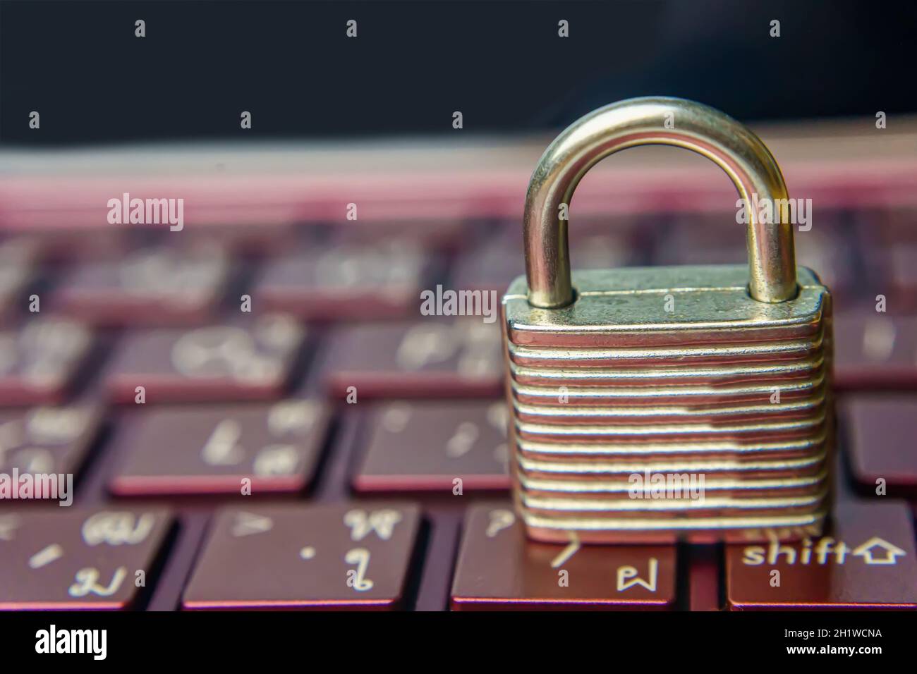 The silver padlock on keyboard laptop. The computer is cyber security. Stock Photo