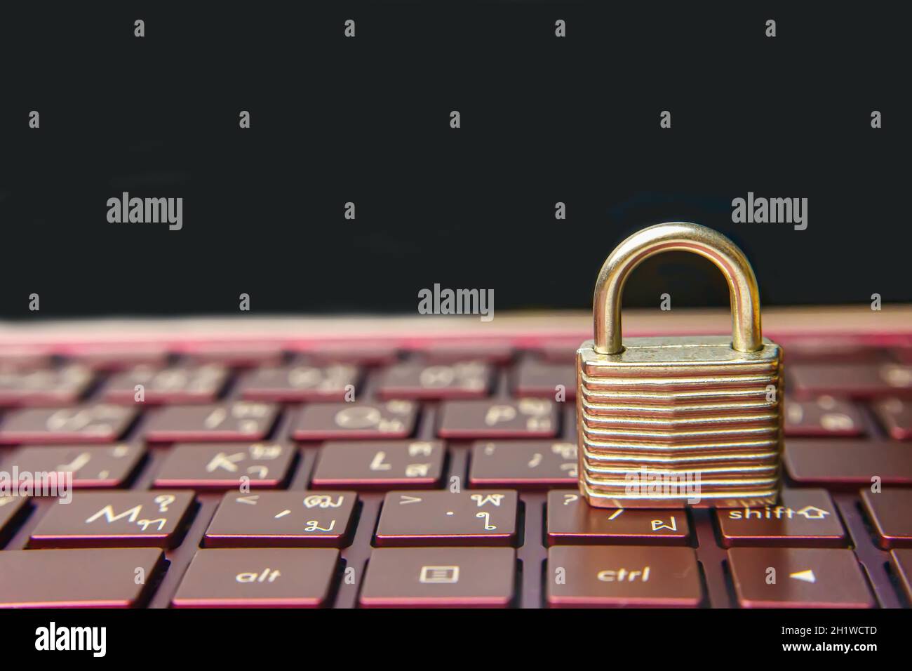 The silver padlock on keyboard laptop. The computer is cyber security. Stock Photo