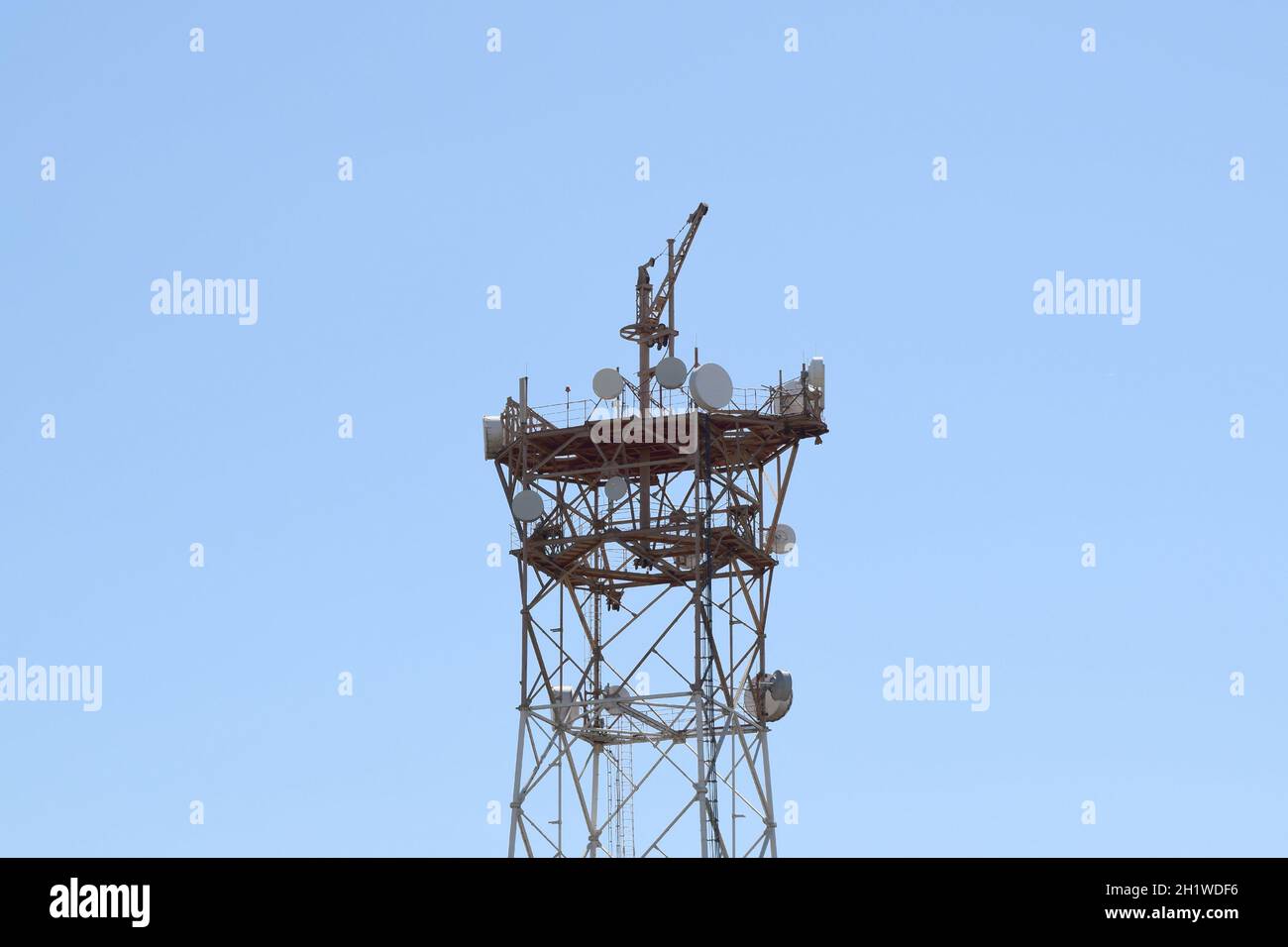 Satellite antennas and repeaters on the tower. Stock Photo Alamy