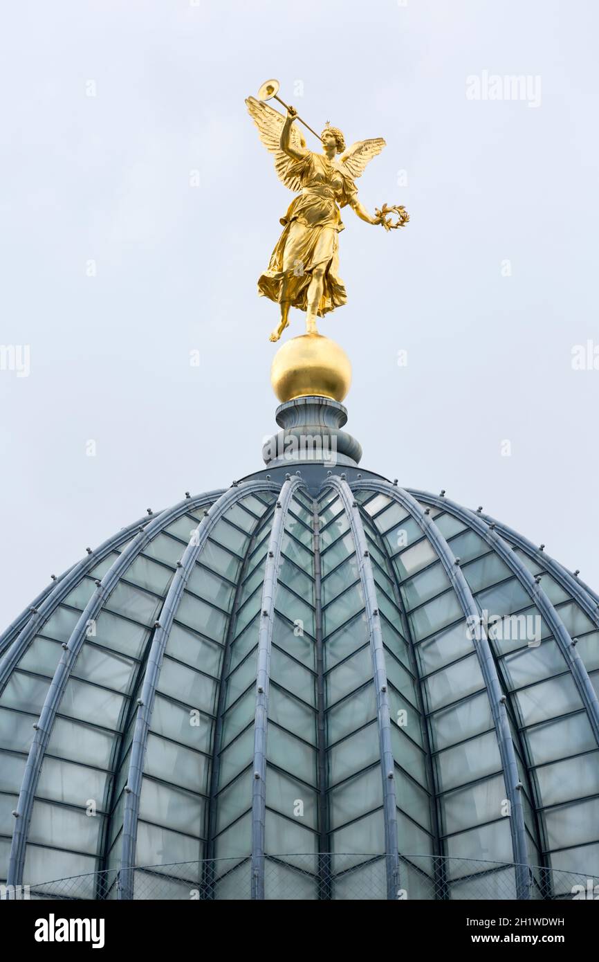 Dresden, Germany - September 23, 2020 : The glass dome with golden statue of Pheme of Dresden Academy of Fine Arts situated on the river Elbe. Dome is Stock Photo