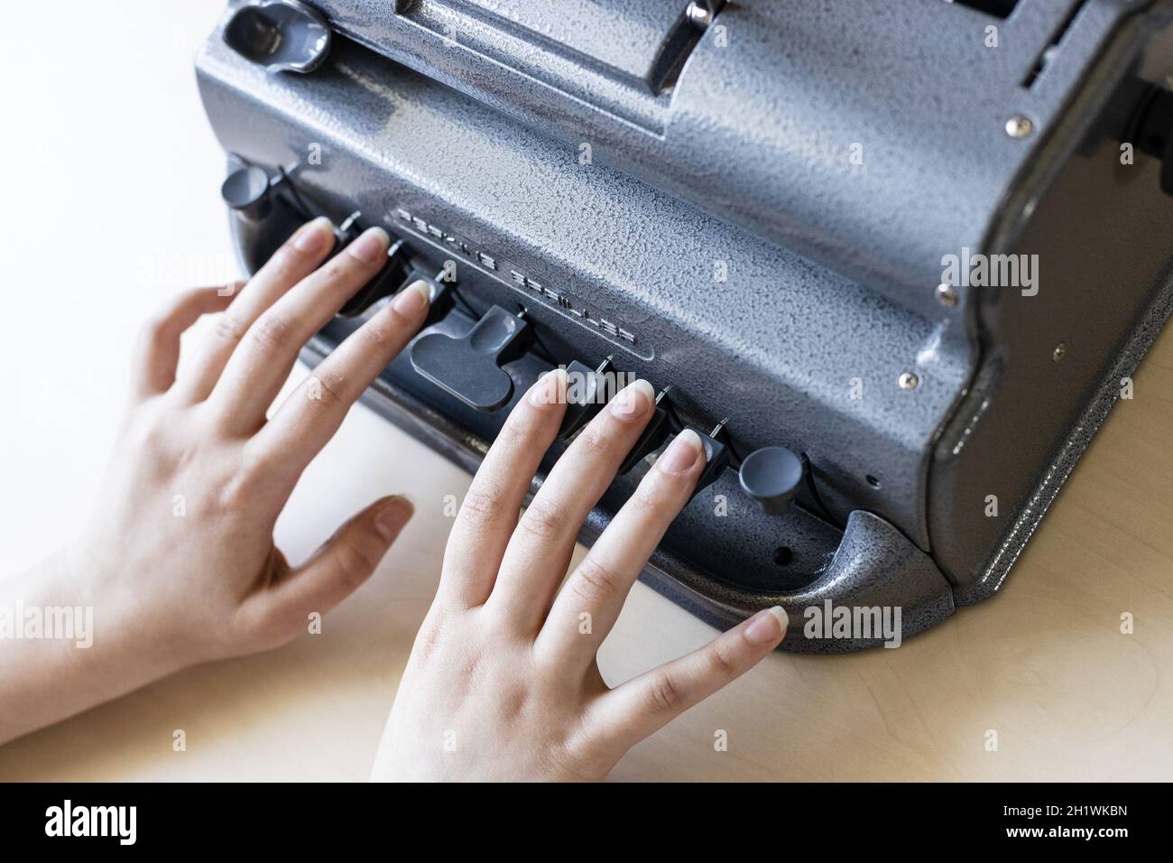 Moscow, Russia - June 5, 2021: fingers touch of Perkins Brailler braille typewriter . The first Perkins Brailler was produced in 1951 by David Abraham Stock Photo