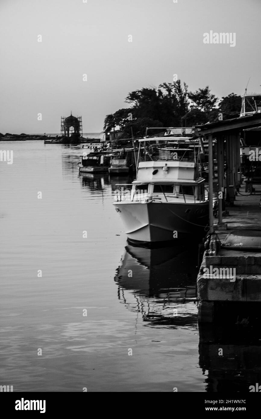 HABANA, CUBA - Aug 13, 2017: A grayscale scenery of in the  fishing boats in a port in Rio de Jaimanitas, Cuba Stock Photo