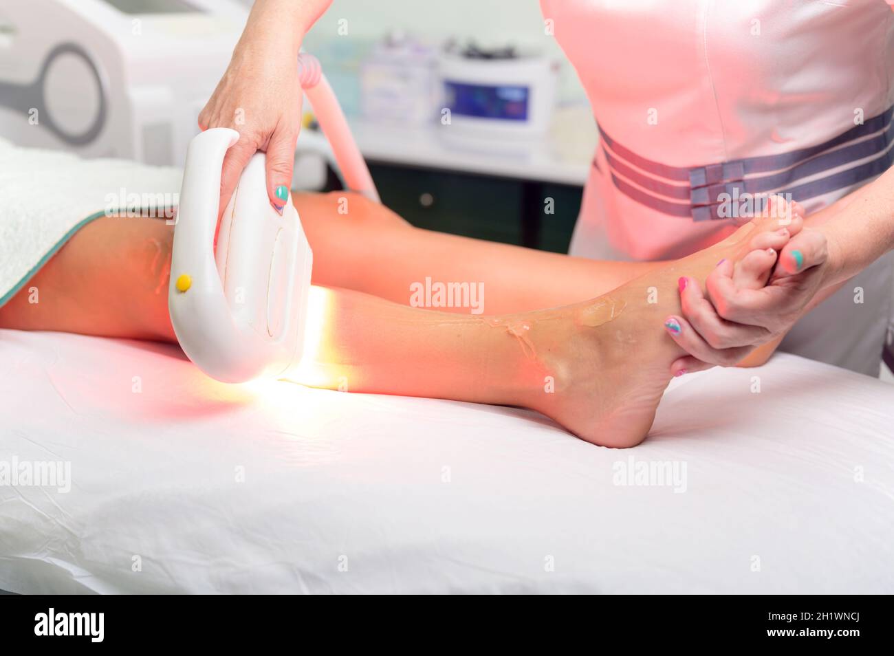 Laser epilation and cosmetology in beauty salon. Cosmetology, spa and hair removal concept. High quality photo Stock Photo