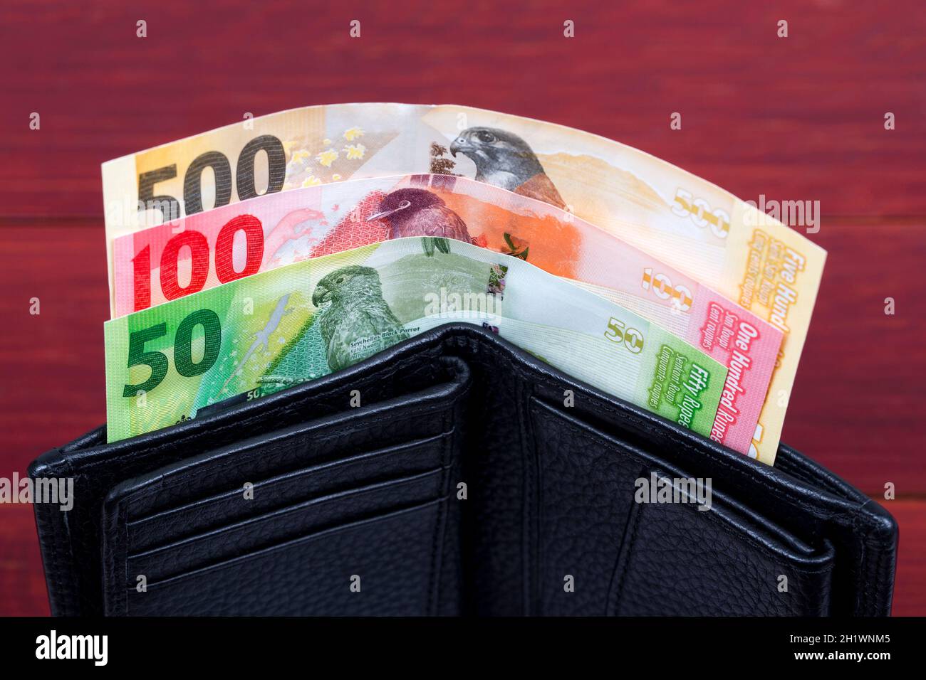 Seychellois rupee in the black wallet Stock Photo