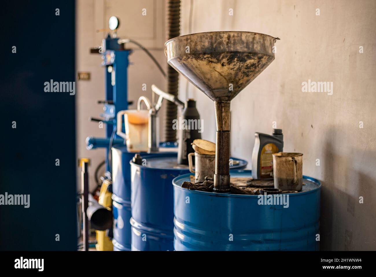 Used engine oil collection in a workshop, used oil barrel Stock Photo